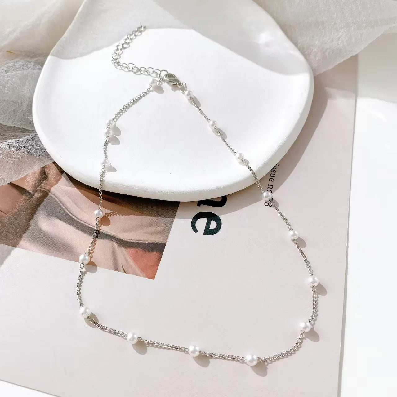 Women's necklace with pearl-embroidered pendant.